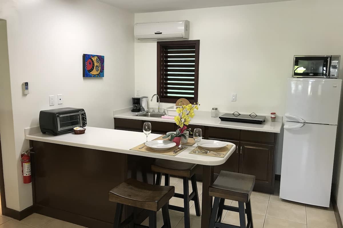 full-sized fridge, microwave, stovetop, coffee/tea maker