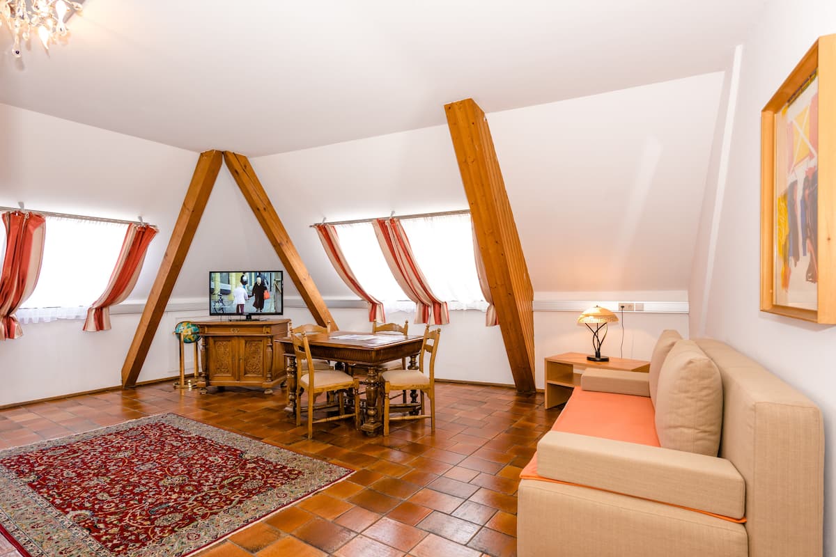 superior double room | living area | flat-screen tv