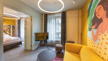 BOUTIQUE Suite with balcony | Living area | 22-inch flat-screen TV with satellite channels, TV, heated floors