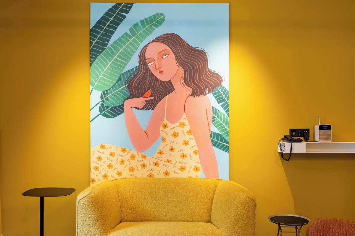 boutique suite with balcony | living area | 22-inch flat-screen tv with satellite channels, tv, heated floors