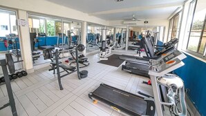 A gym with treadmills, weight machines, and free weights. - Fini Hotel Bobende (Limbe)