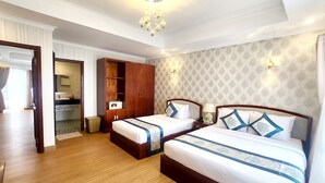 A hotel room with two beds, a wardrobe, a vanity with a mirror, and a chandelier. - Rang Dong Hotel (Ho Chi Minh City)