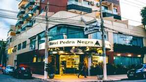 A multi-story hotel with balconies, a sign indicating it is a hotel, and a visible entrance. - Hotel Pedra Negra (Governador Valadares)