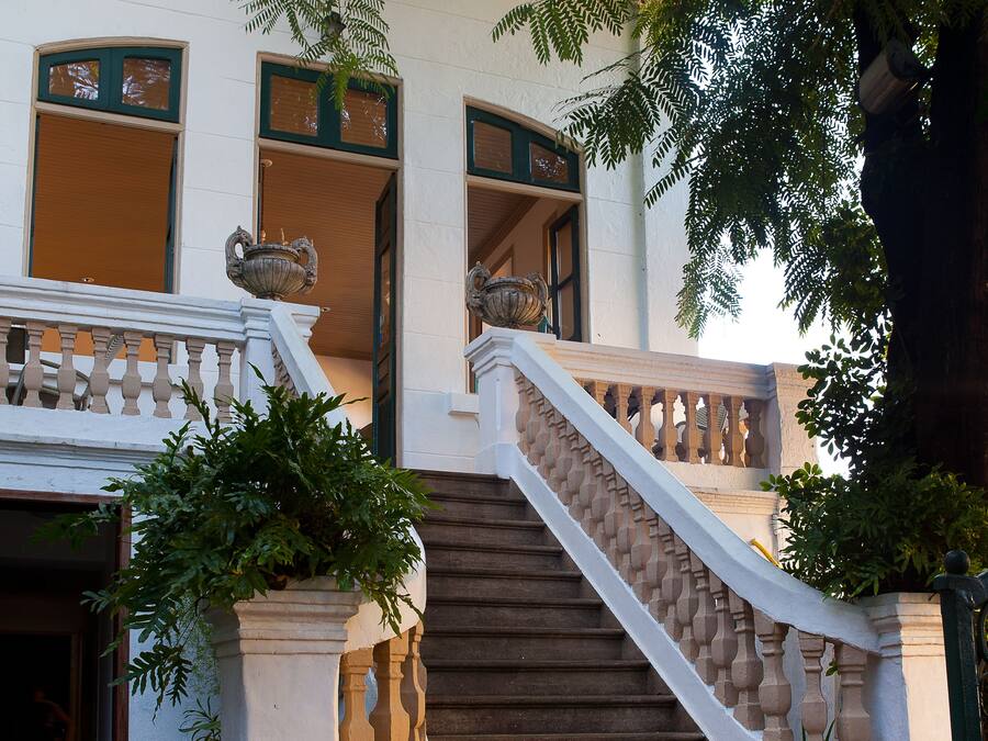 A staircase with a white balustrade leading to a building entrance.