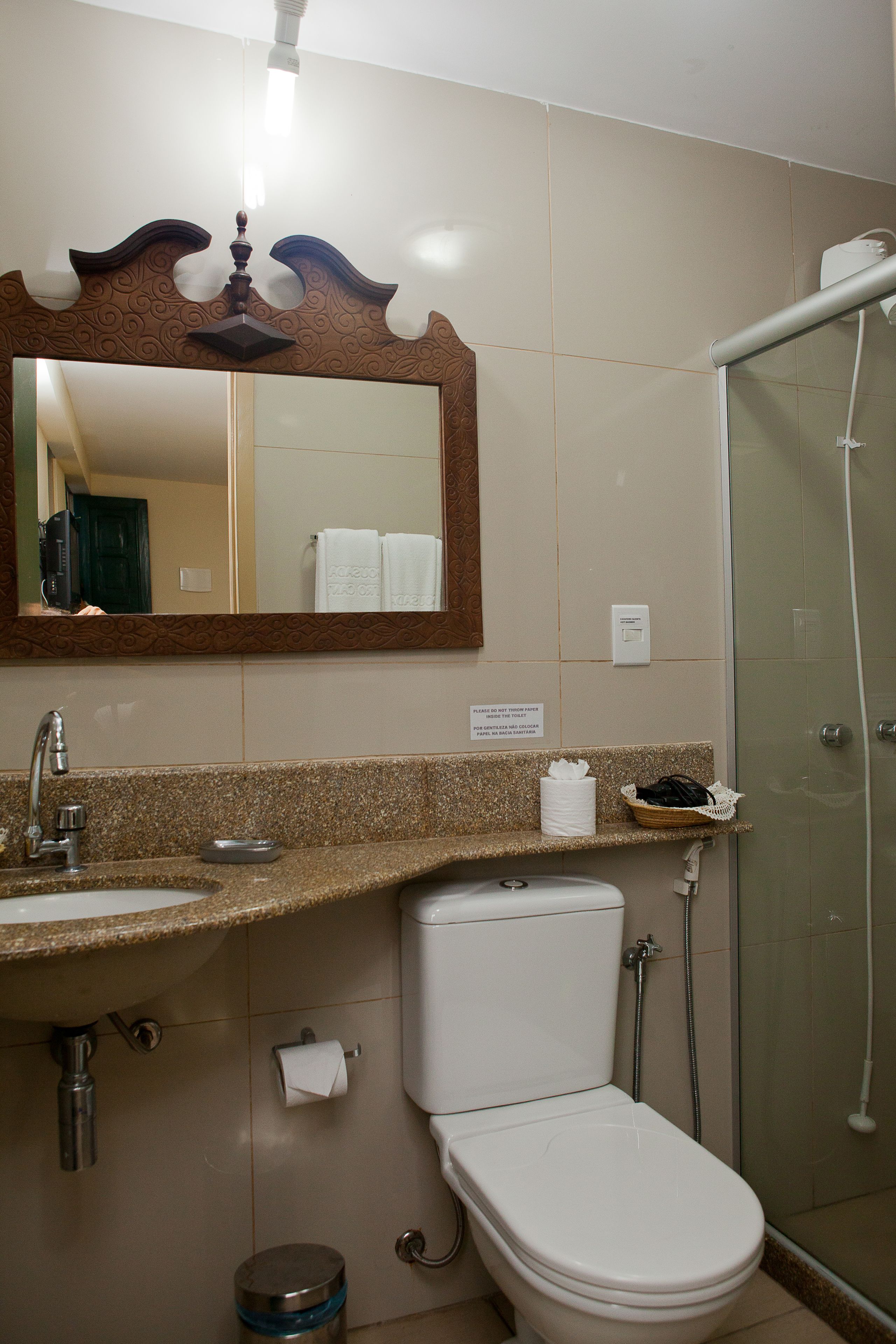 A bathroom with a sink, toilet, and shower.