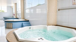 A spa area with multiple hot tubs, a fire extinguisher, and a handrail. - THE - Tropicanas Hotel e Eventos (Florianópolis)