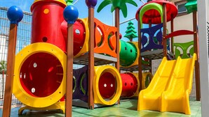 A children's play area with various colorful play structures, including slides and tunnels. - THE - Tropicanas Hotel e Eventos (Florianópolis)