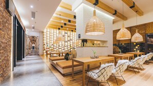 A modern restaurant with wooden tables, white chairs, and hanging wicker lamps. - Atour Light Hotel Jinli Chengdu (Chengdu)