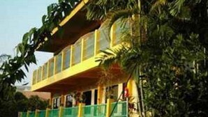 A building with a yellow facade and a balcony. - Klong Muang Inn (Krabi)