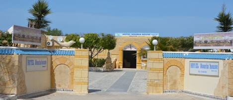 The entrance to Hotel Houria House with a clear pathway leading to the reception area.