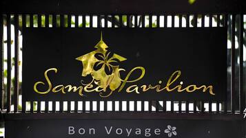 A sign with the text "Samed Pavilion" and "Bon Voyage" with a decorative emblem.