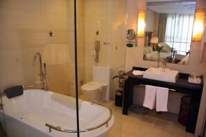 Enjoy a refreshing shower or soak in the bathtub, complete with a handheld showerhead and wall-mounted faucet.
