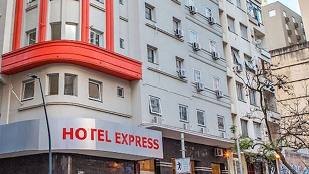 A hotel named HOTEL EXPRESS with a modern facade, multiple floors, and a prominent red accent on the corner.
