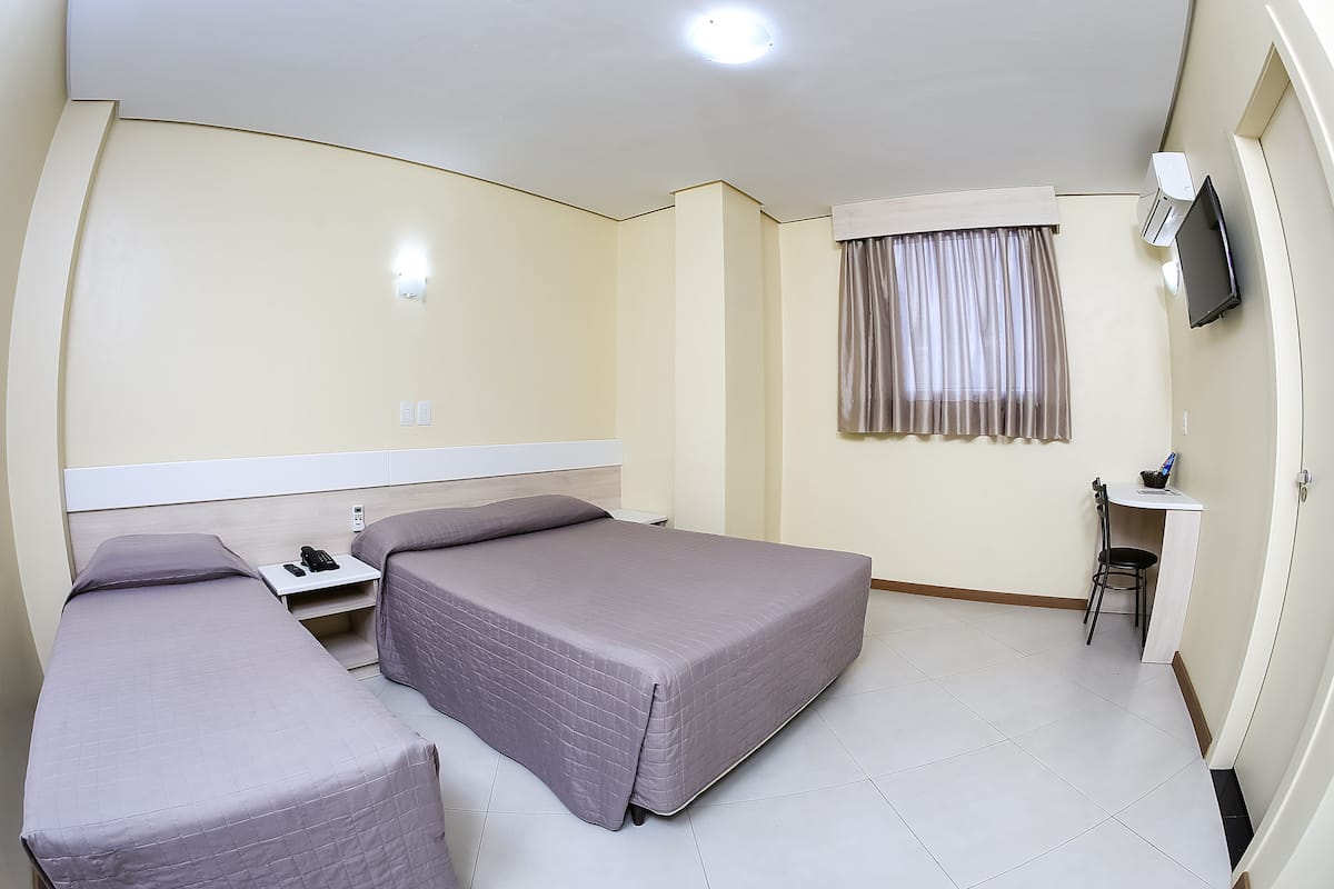Family Triple Room | Minibar, in-room safe, desk, blackout curtains