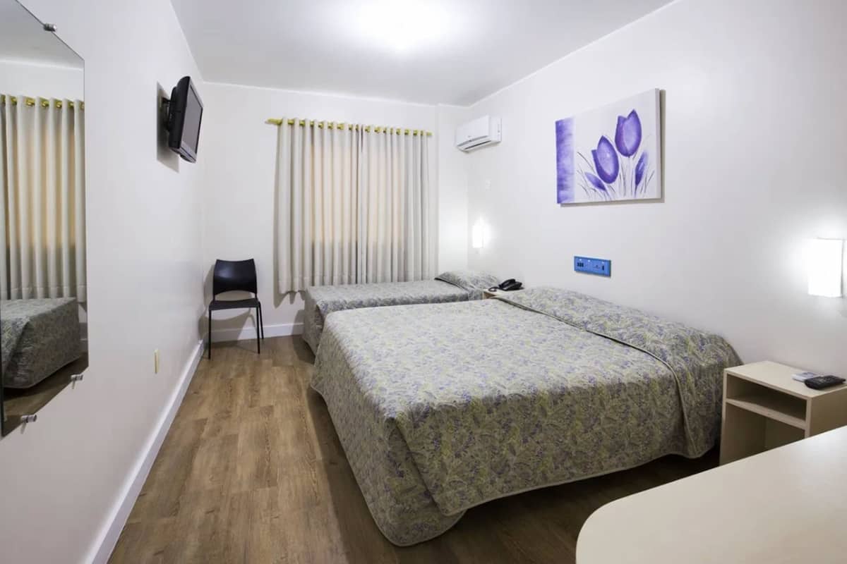Triple Room | Minibar, in-room safe, blackout drapes, iron/ironing board