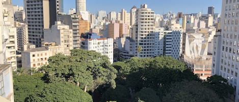 A cityscape with dense high-rise buildings and a central area with trees.