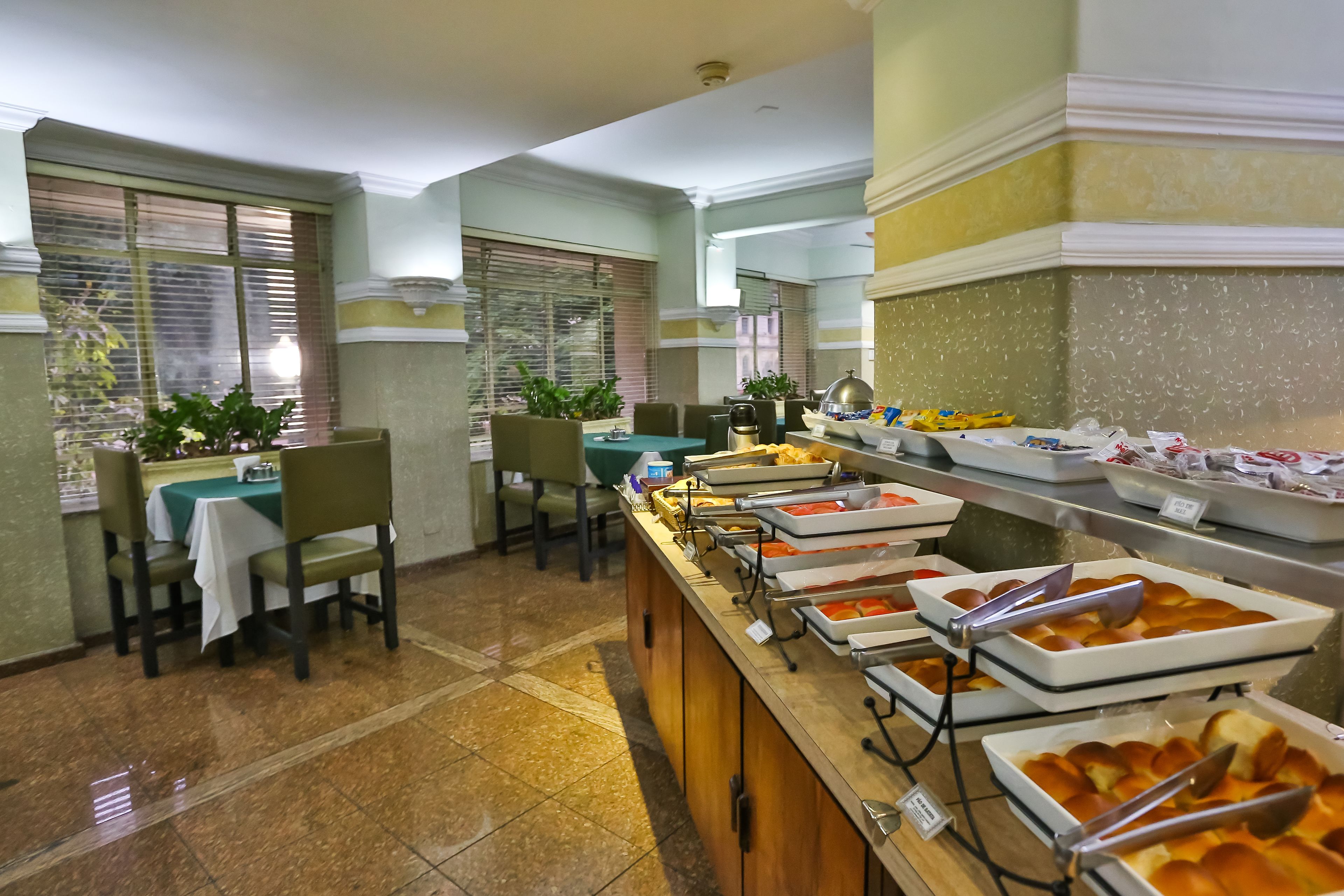 A buffet area with multiple serving stations, chairs, and tables.