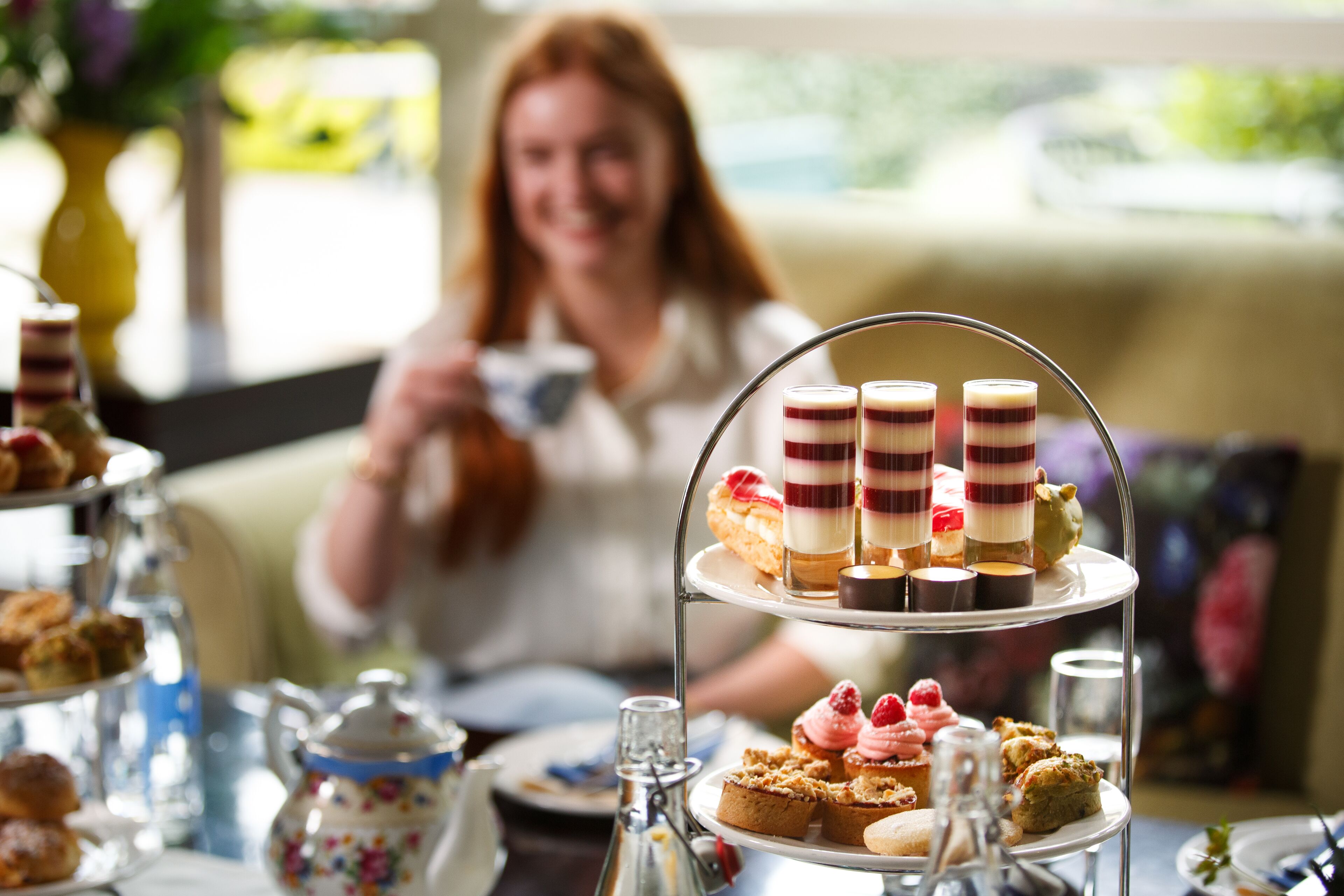 A three-tiered dessert stand with various pastries and desserts.