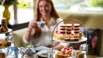 A three-tiered dessert stand with various pastries and desserts.