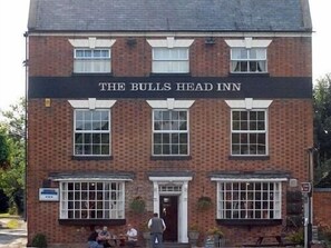 A two-story brick building with a sign reading "The Bulls Head Inn". - The Bulls Head Inn (Worcester)
