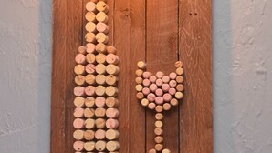 A wooden wall with corks arranged in a pattern.