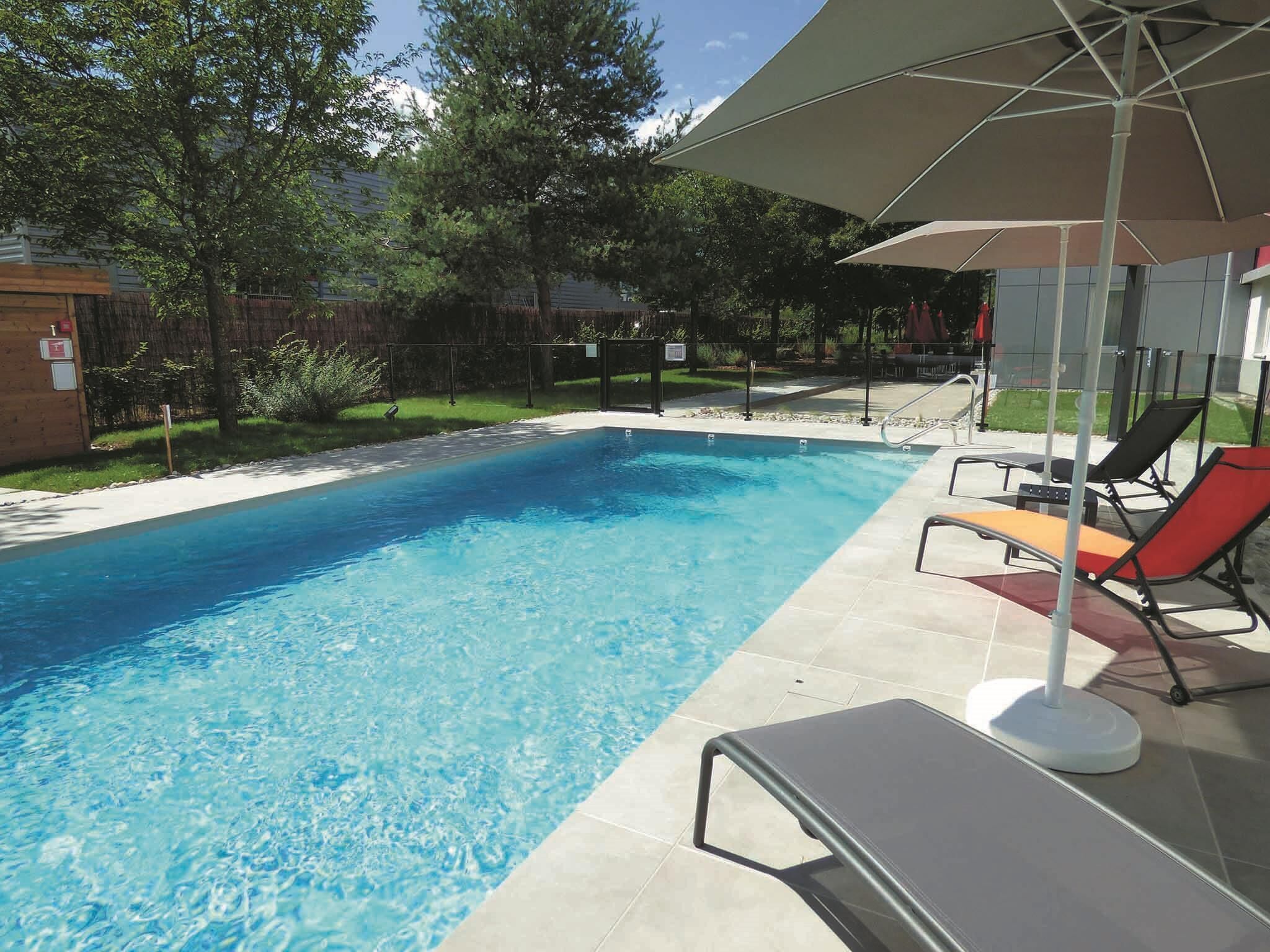 Seasonal outdoor pool, open 10:00 AM to 9:00 PM, pool loungers