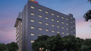 A modern building with the name "GINGER" on the top. It has multiple floors and windows. - Ginger Noida Sector 63 (Noida)