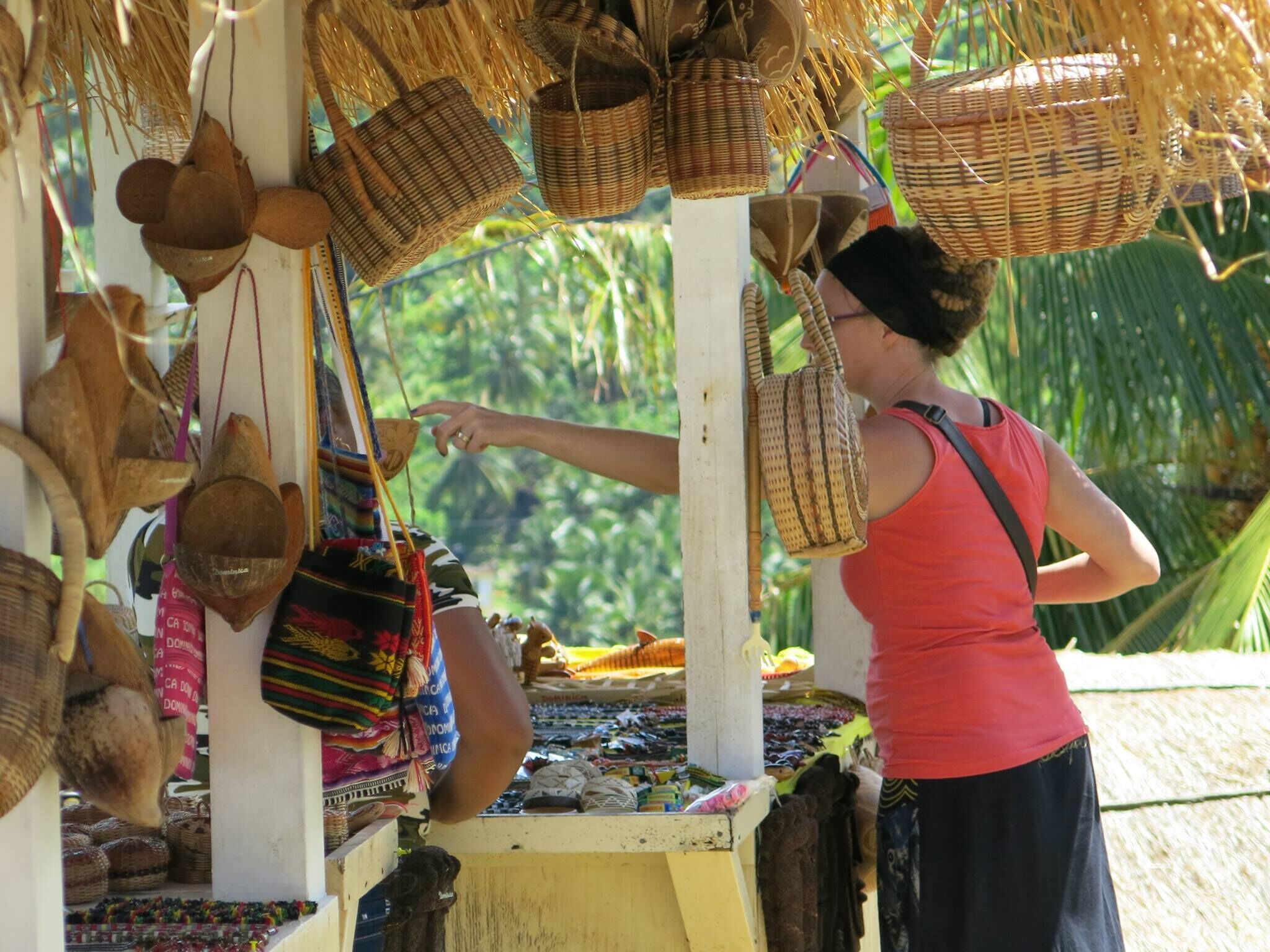 A market stall with various woven baskets and colorful textiles.