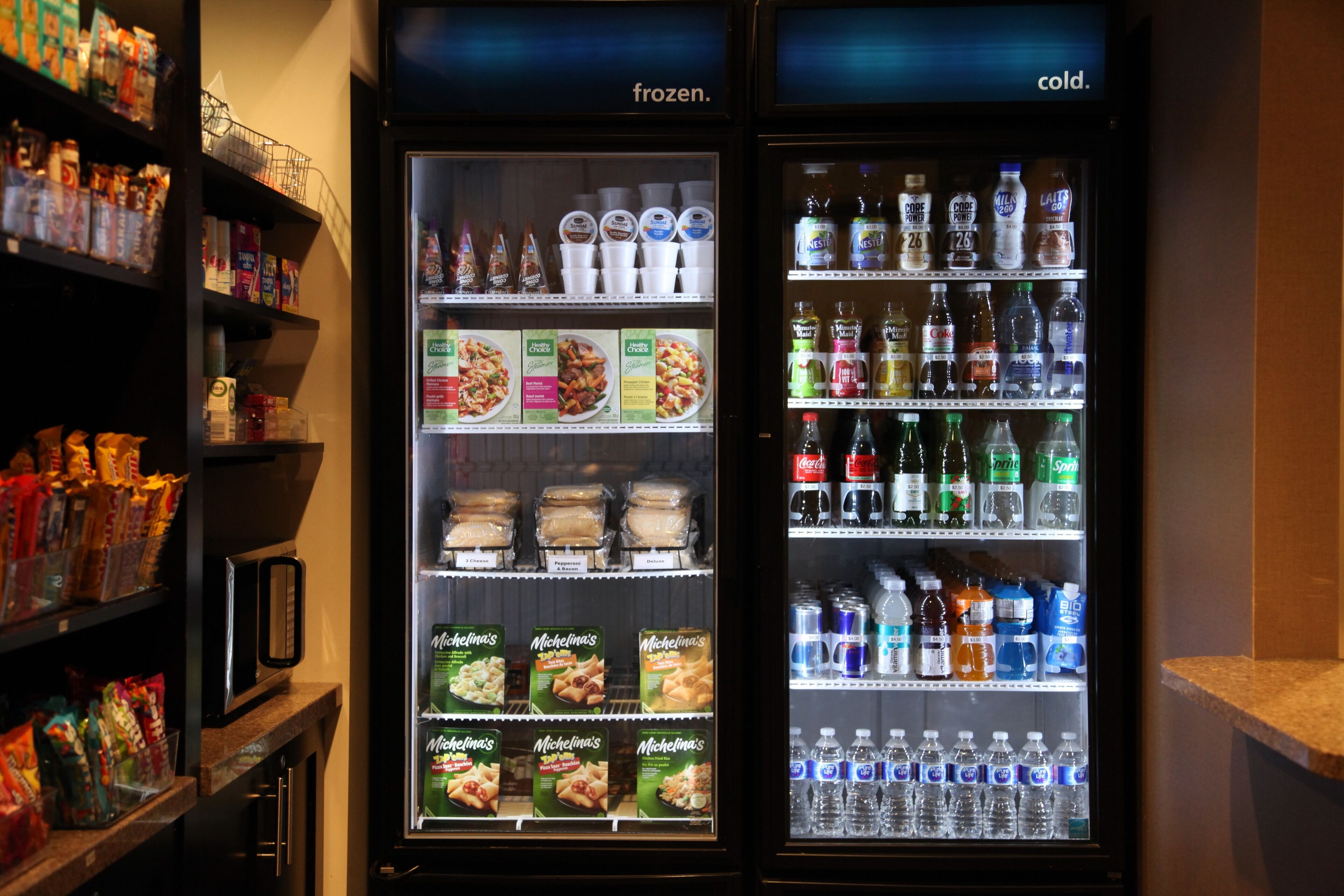 Two refrigerated display cases with frozen and cold beverages, and packaged food items.