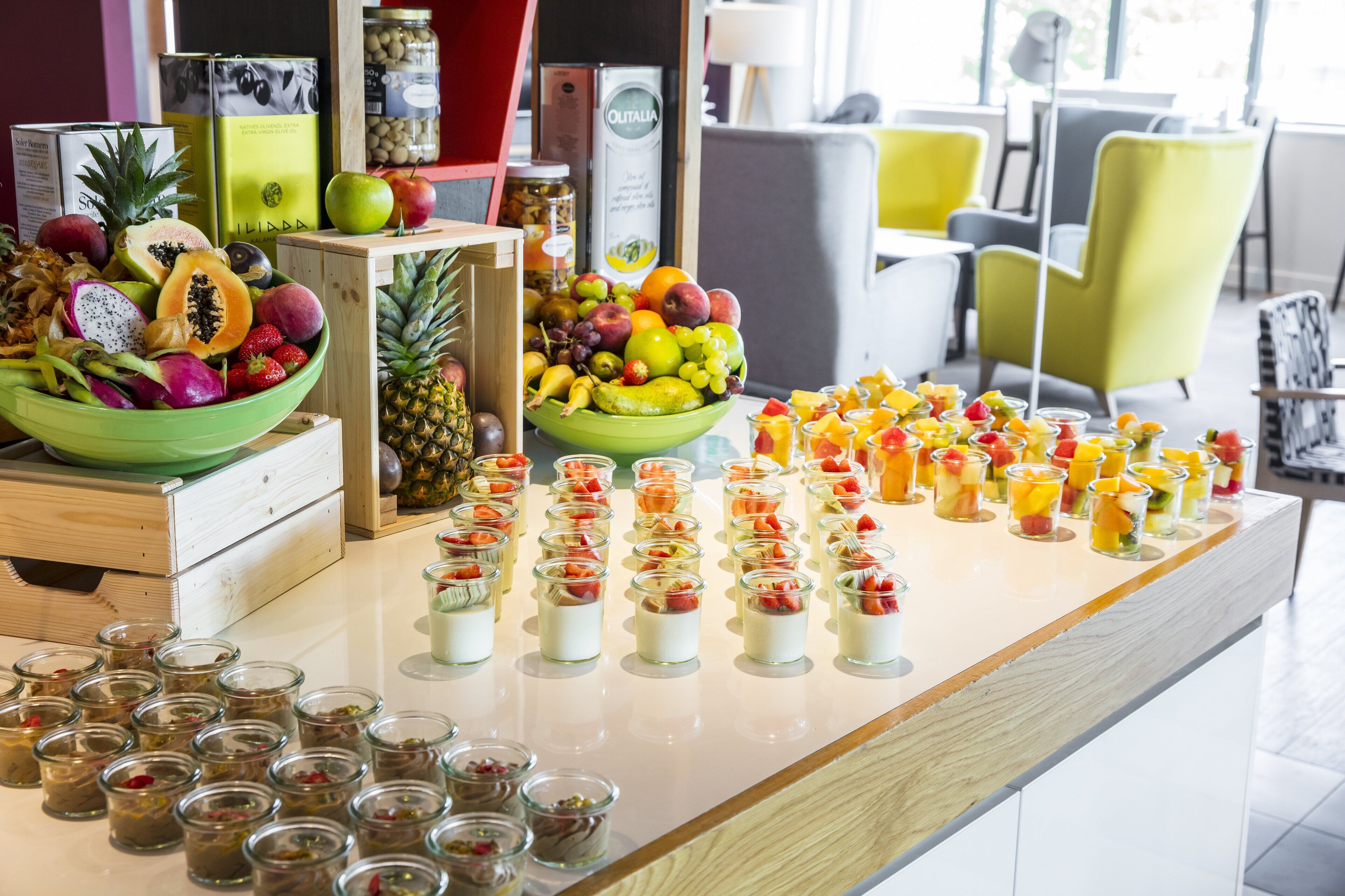 A buffet with various fruits and desserts.