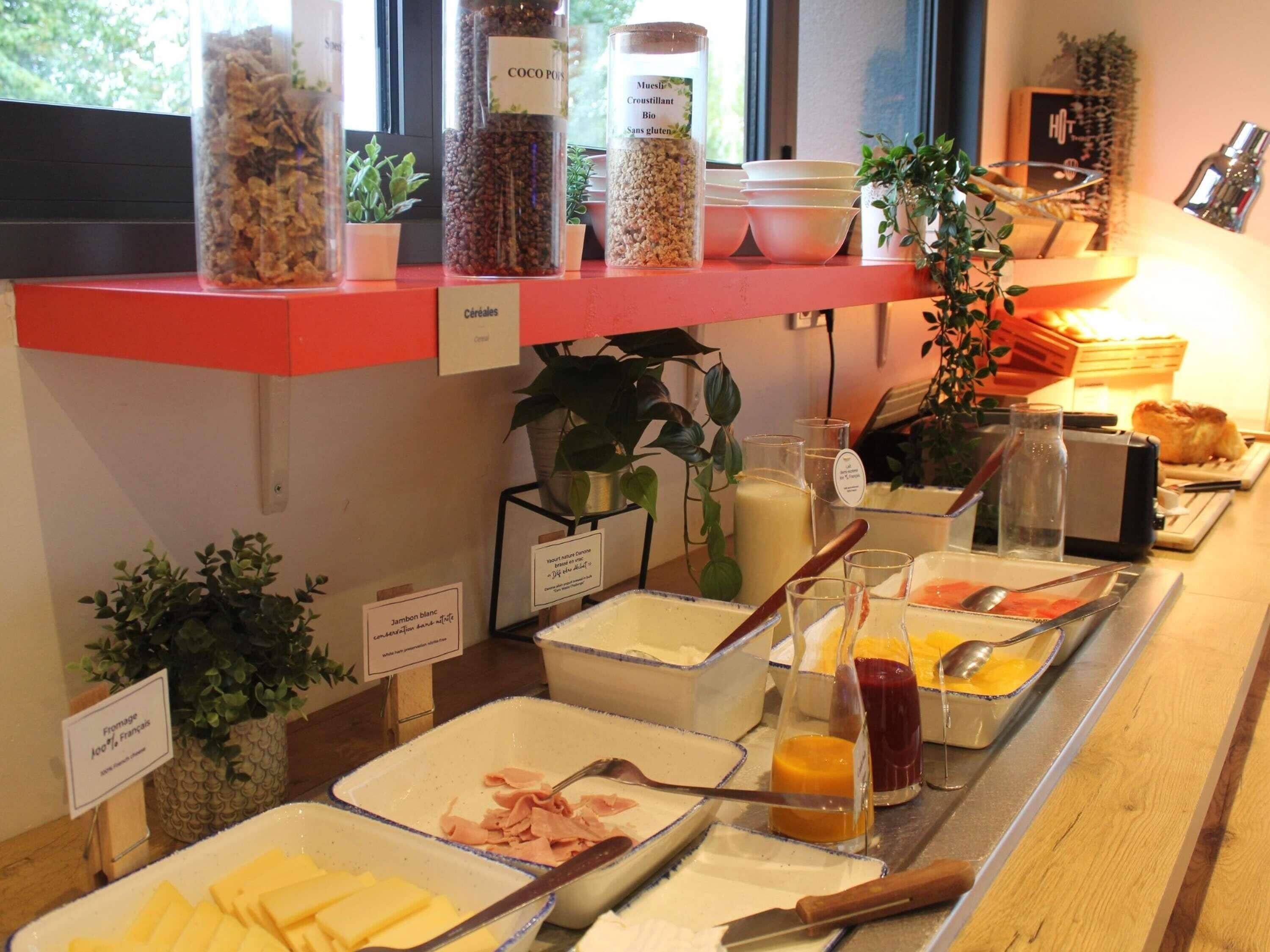 A breakfast buffet with various food items and condiments.