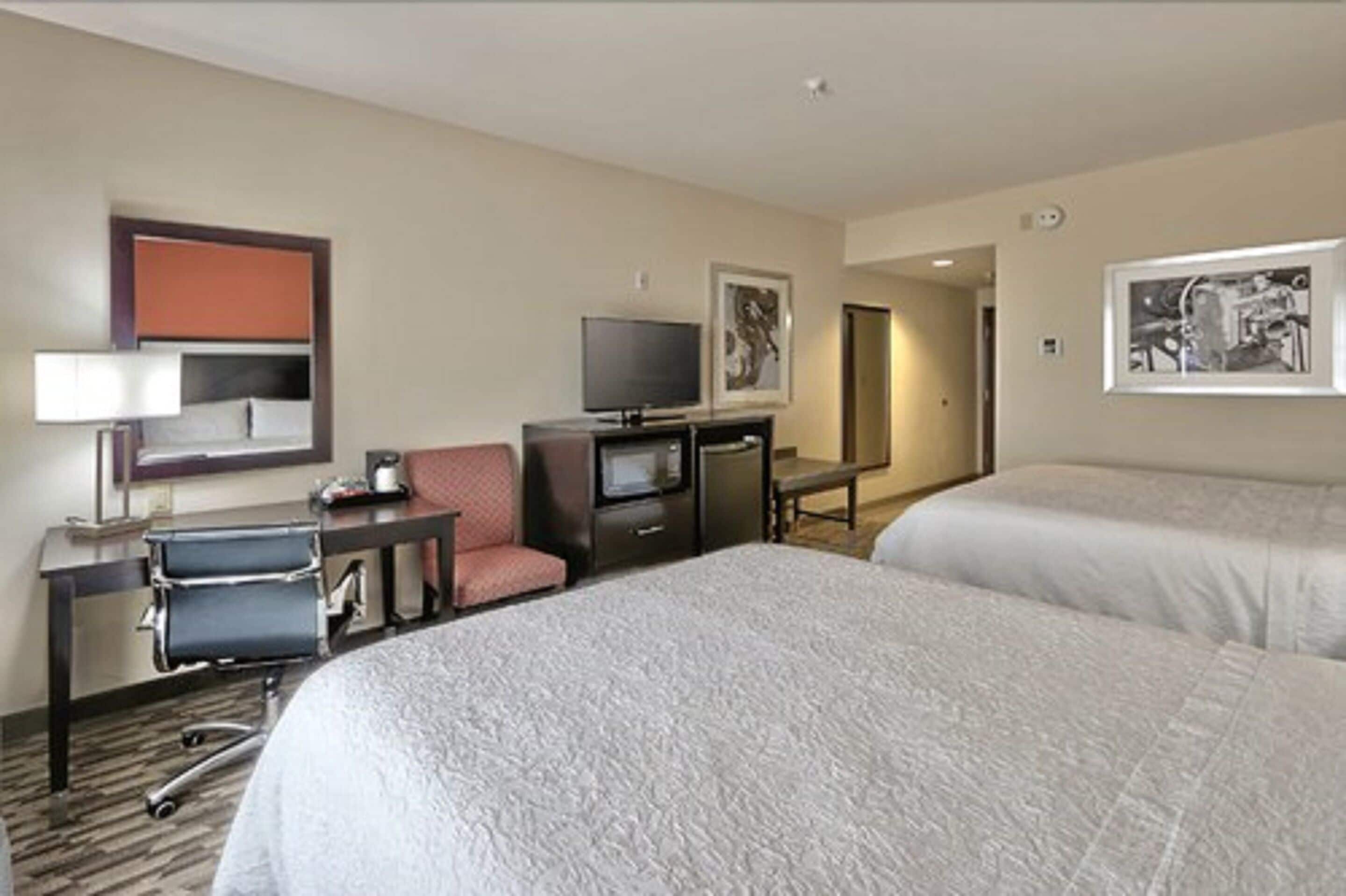 room, 2 queen beds, refrigerator & microwave | iron/ironing board, cots/infant beds, free wifi, bed sheets