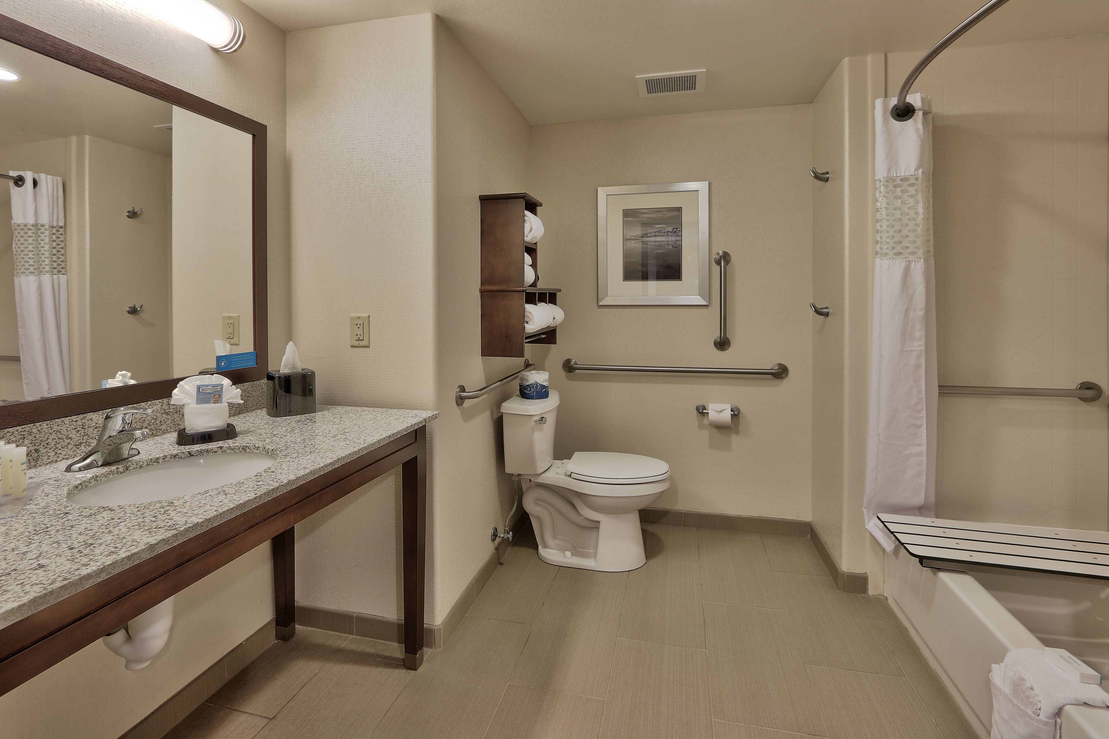 A bathroom with a sink, toilet, and shower.