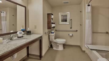 A bathroom with a sink, toilet, and shower.