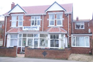 A two-story brick building with a sign for 'Serena Court Private Hotel'. - Serena Court Hotel (Skegness)