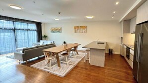 A modern apartment with a dining area, kitchen, and living space. - Boulcott Suites (Wellington)