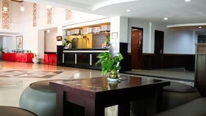 A spacious lobby with a reception area, a bar, and seating arrangements. - Nirmala Hotel and Convention Centre (Denpasar)