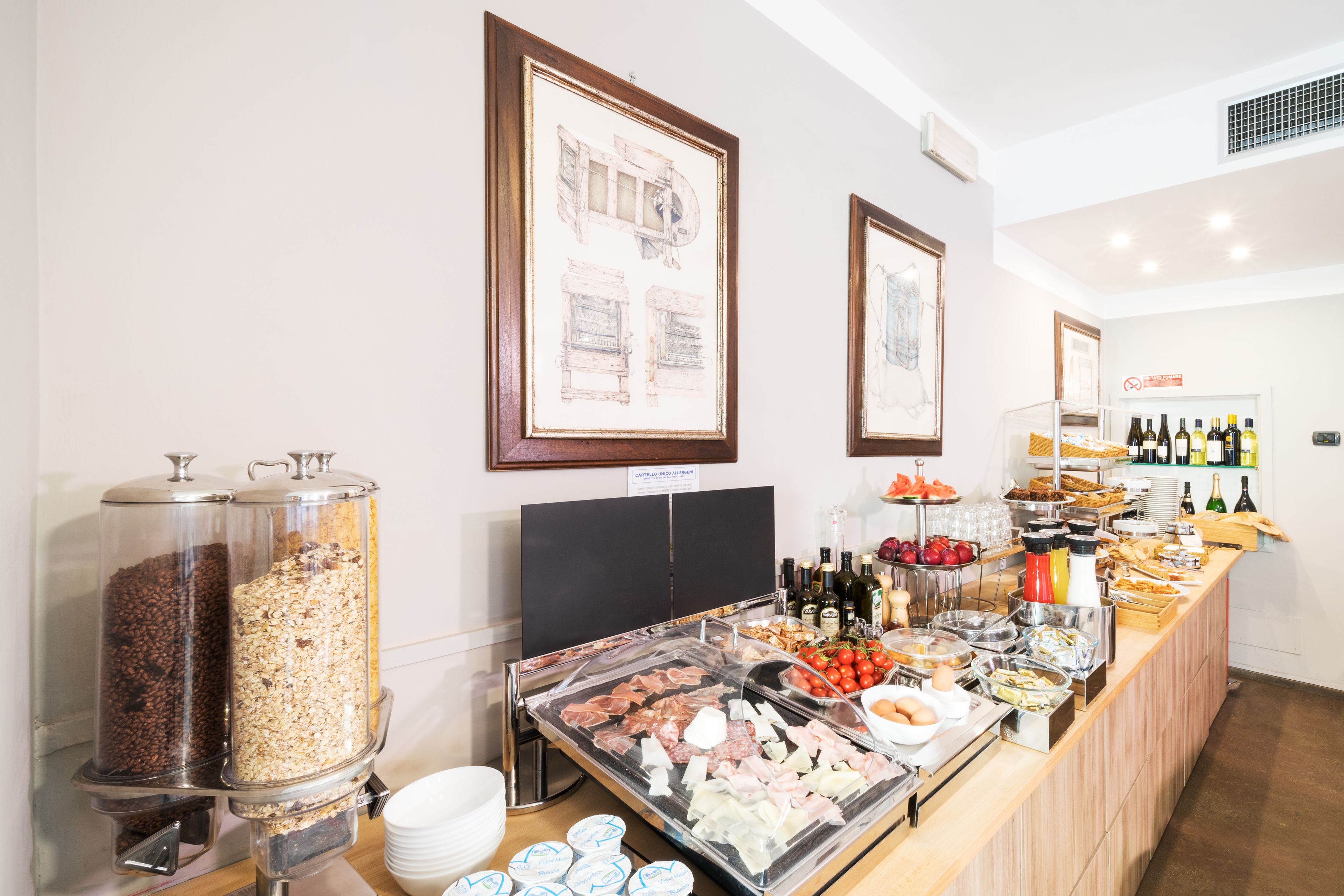 A buffet setup with various food items, a coffee station, and a wine selection.