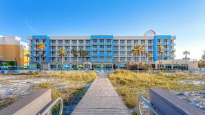 A hotel with a central courtyard, multiple balconies, and a beach view. - Holiday Inn Resort Fort Walton Beach by IHG (Fort Walton Beach)