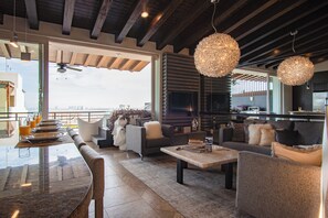 Andrew Christian Penthouse + Jacuzzi | Living room | 55-inch TV with satellite channels - Pinnacle Resorts 180 (Puerto Vallarta)