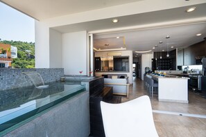 Andrew Christian Townhouse + Jacuzzi | Living area | 55-inch TV with satellite channels - Pinnacle Resorts 180 (Puerto Vallarta)