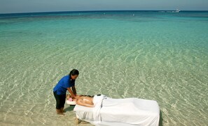 On the beach, white sand, sun loungers, beach umbrellas