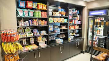 A grocery store with shelves stocked with various snacks, beverages, and packaged goods.