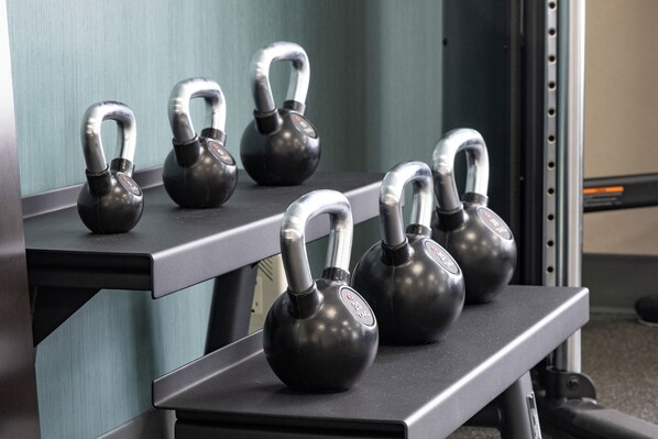 A set of kettlebells on a rack in a gym. - Hampton Inn & Suites by Hilton St. John's Airport (St. John's)