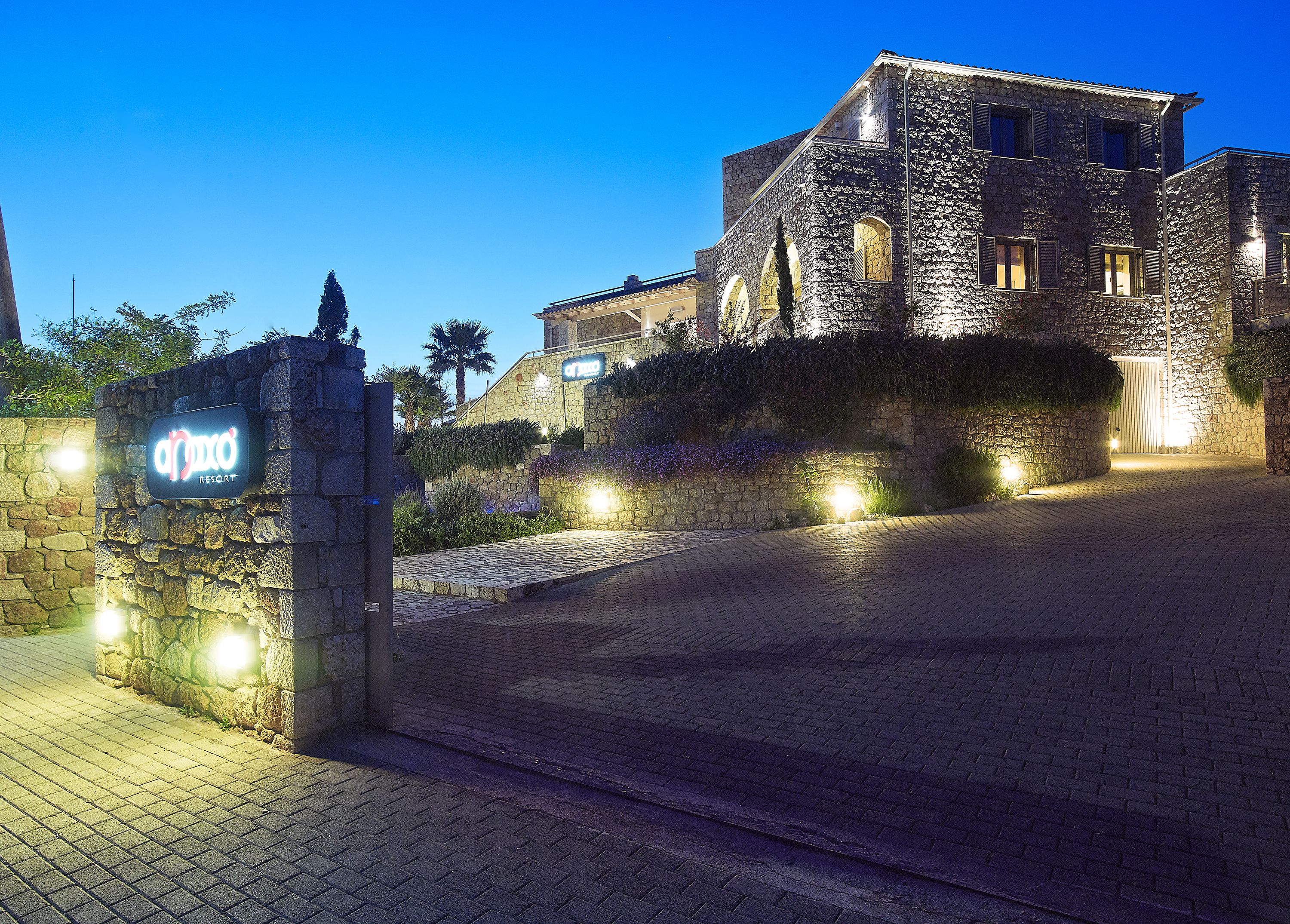 A stone building with a sign reading "APPOXO RESORT".