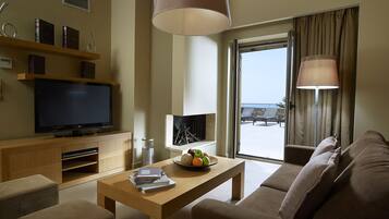 A modern living room with a flat-screen TV, wooden coffee table, and a sofa.