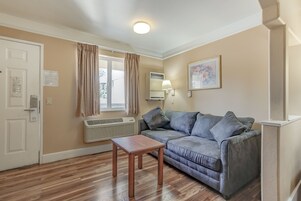 Exclusive Suite, 1 King Bed | Living area | 30-inch flat-screen TV with satellite channels, TV