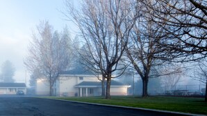 A residential area with houses, a street, and a park. - Shasta Pines Motel & Suites (Burney)