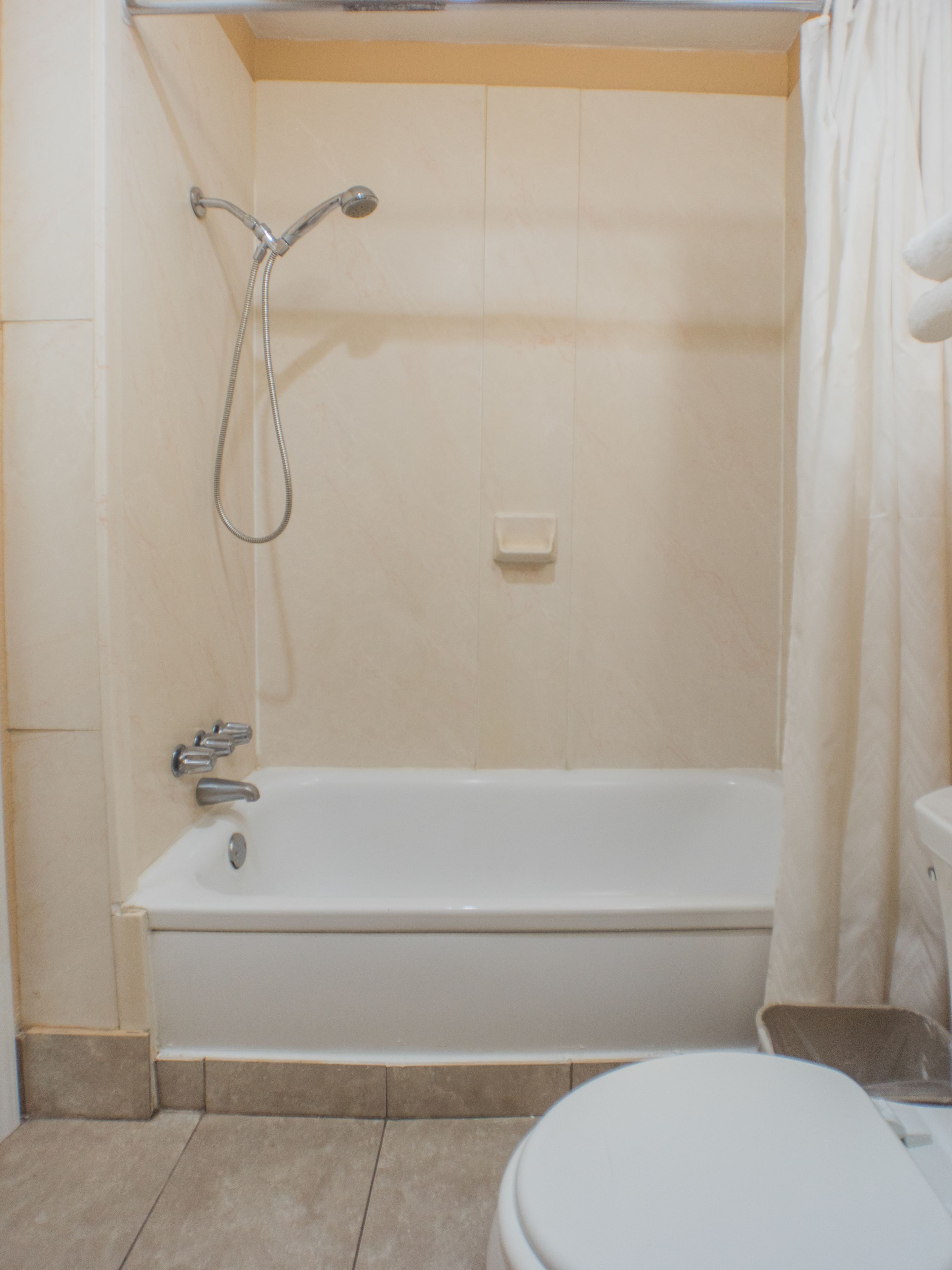 A bathroom with a bathtub, a shower, and a toilet.