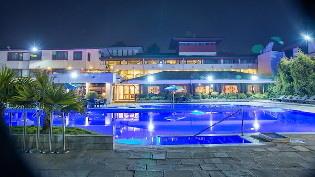 A hotel with a swimming pool, outdoor seating, and a well-lit facade. - Hotel Annapurna (Kathmandu)
